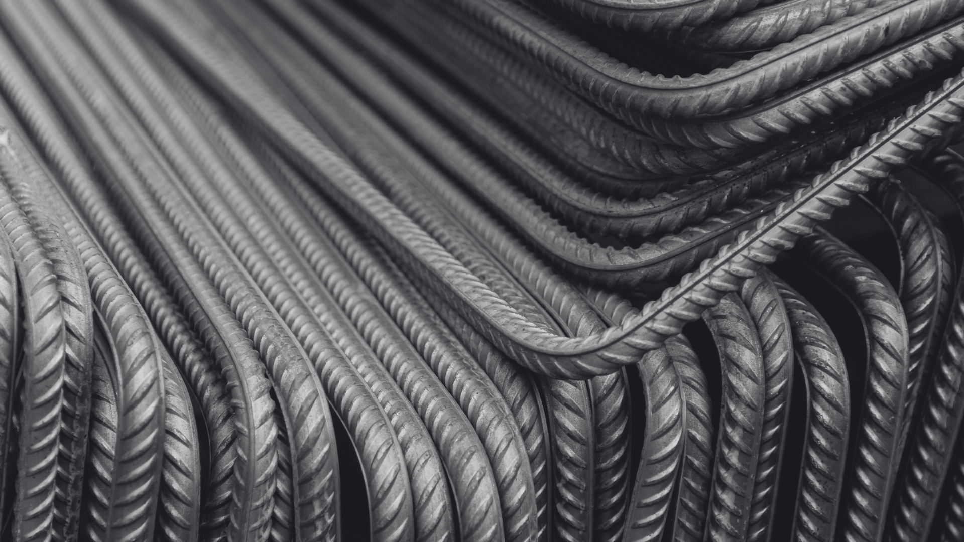 A bunch of steel bars are laying on the ground