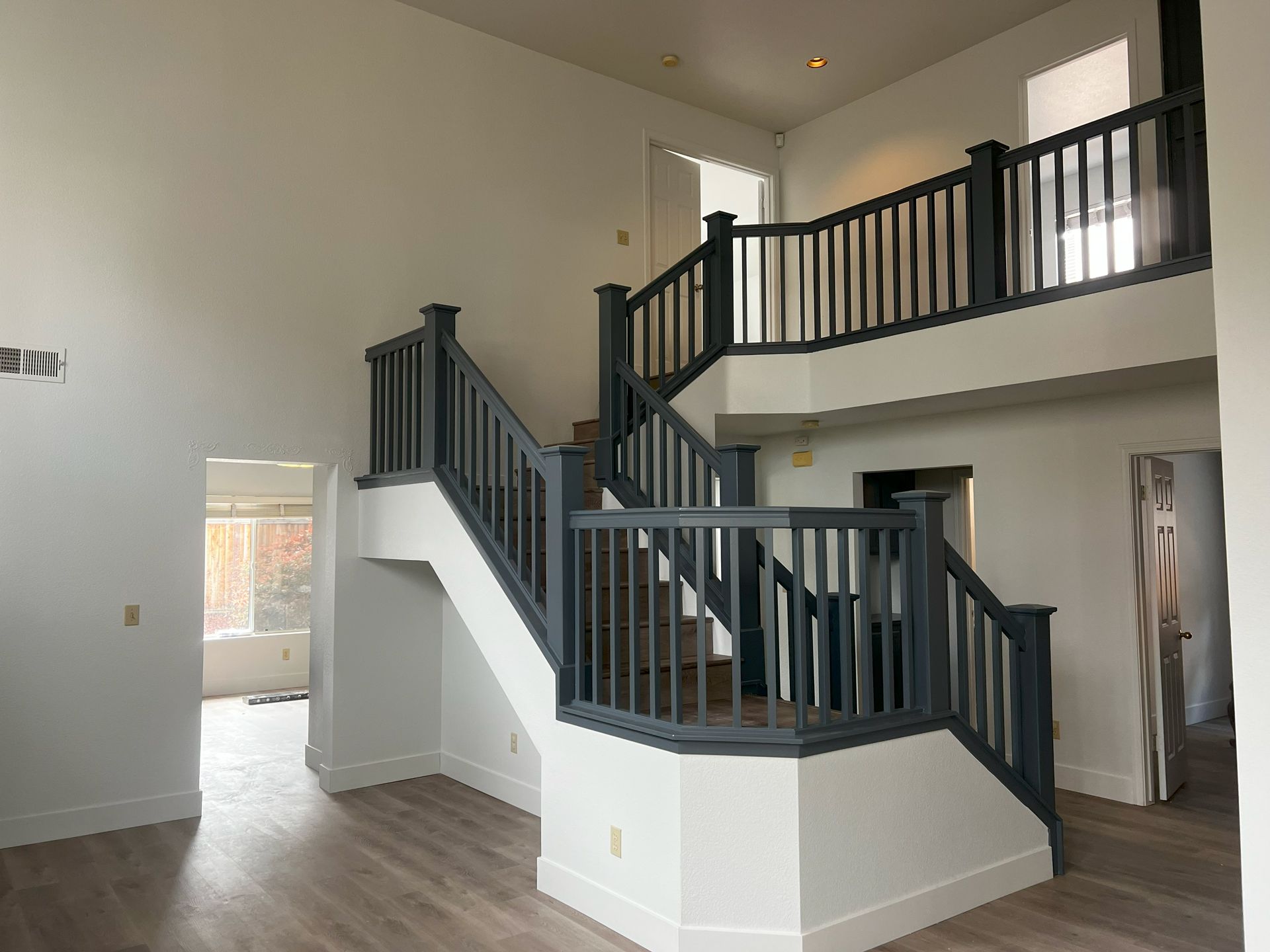 An empty house with a staircase leading up to the second floor.