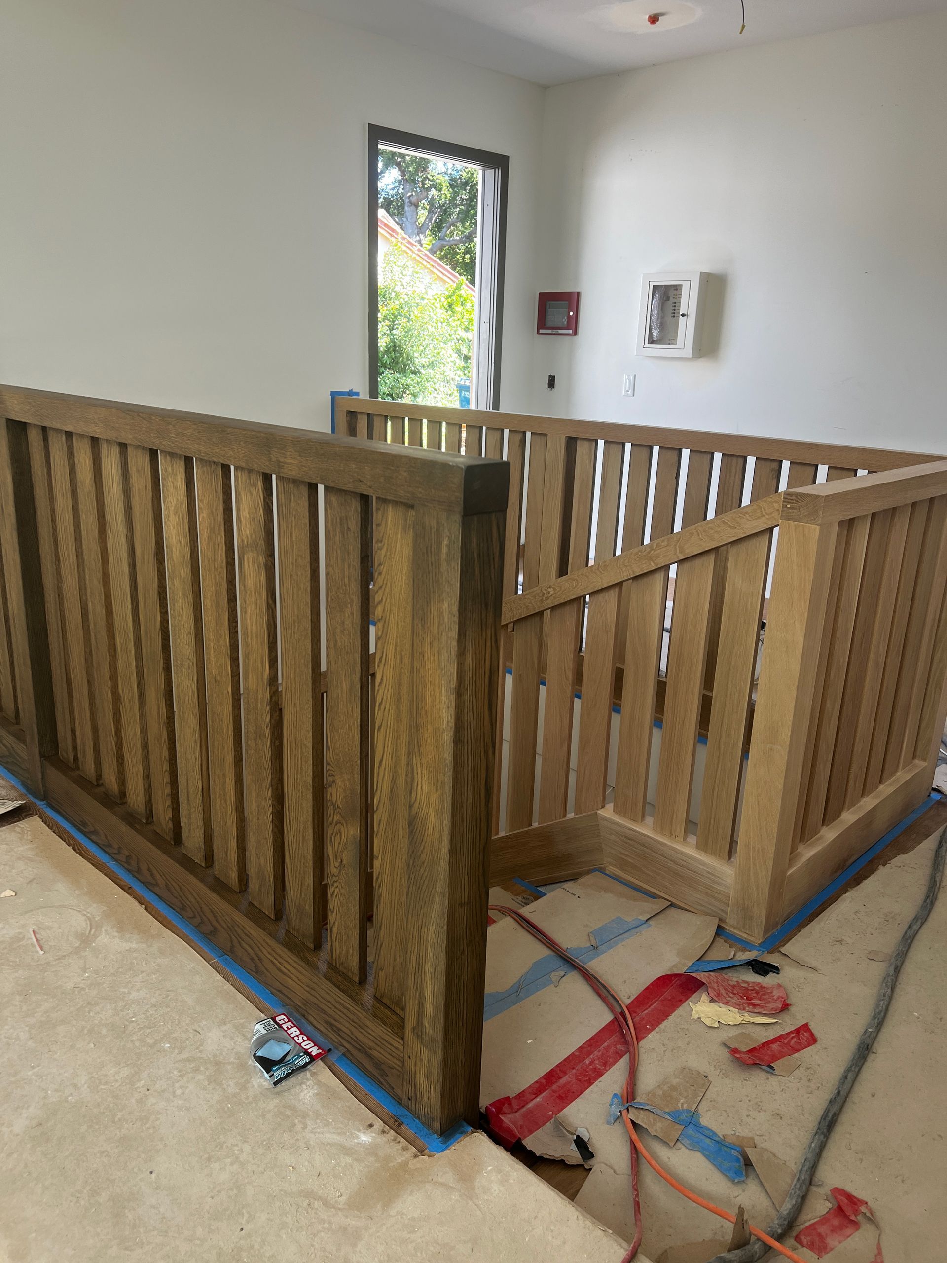 A wooden railing is sitting on the floor in a room