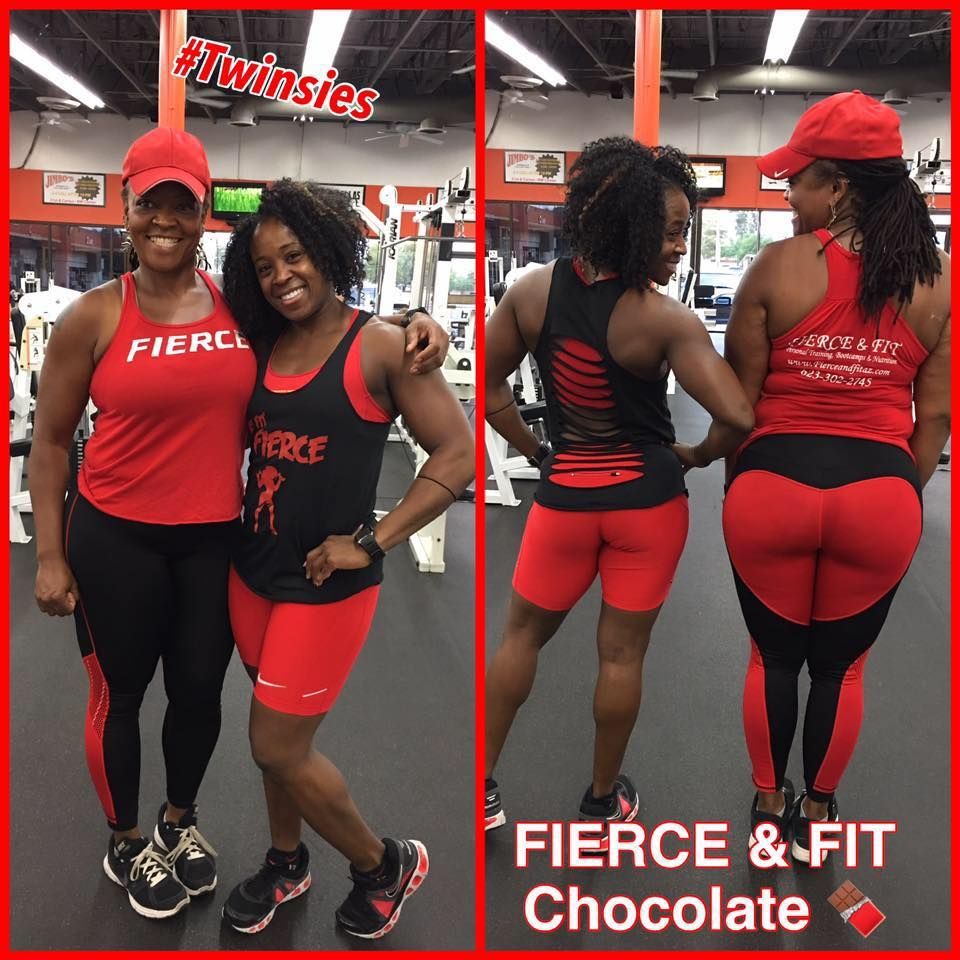 Two women are posing for a picture in a gym wearing fierce and fit chocolate outfits