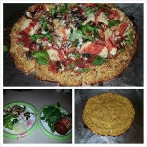 A pizza is sitting on a table next to a plate of food.