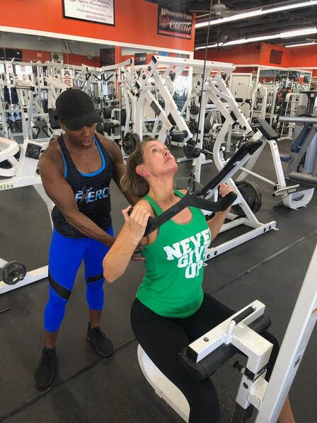 A woman in a green tank top that says never give up