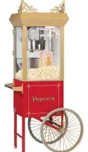 Red popcorn cart with glass display and large wheel, filled with popcorn
