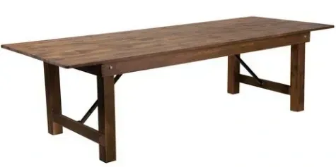 Wooden dining table with trestle legs and a rustic finish