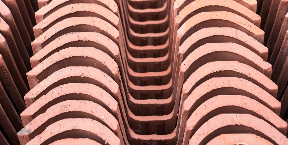 A Close Up of a Stack of Bricks Stacked on Top of Each Other — Leonard Gray Roof Tiling In Ballina, NSW