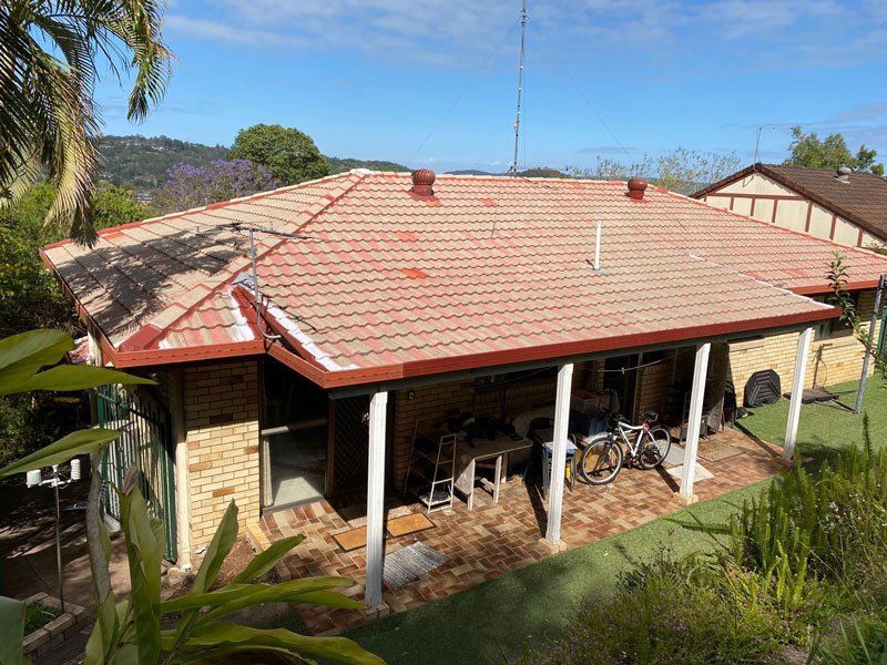 A House With a Red Tiled Roof and a Porch — Leonard Gray Roof Tiling In Goonellabah, NSW