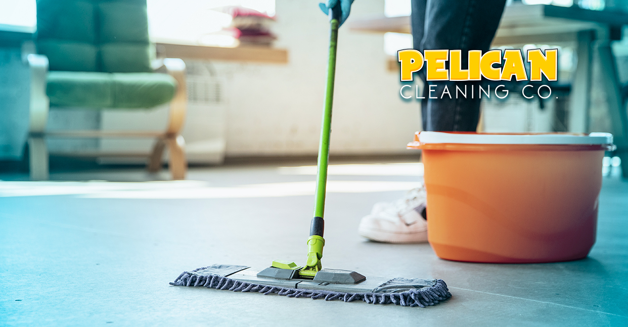 A person is cleaning the floor with a mop and bucket.