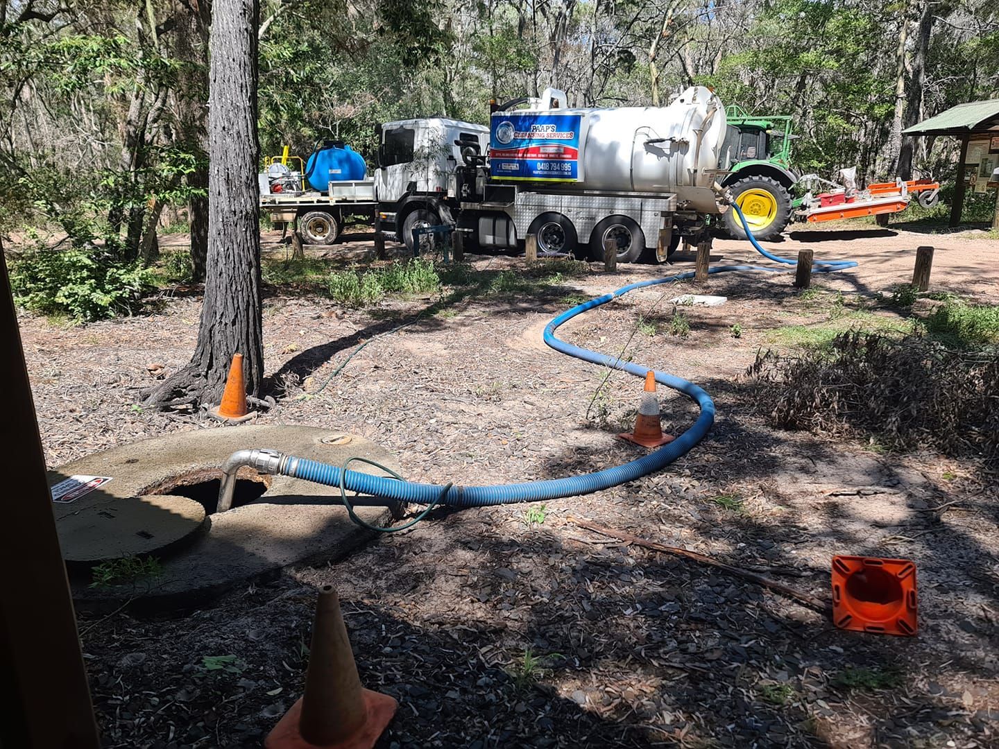 Septic Truck Pumping a Tank in a Wooded Area — Paap's Cleansing Services in Branyan, QLD