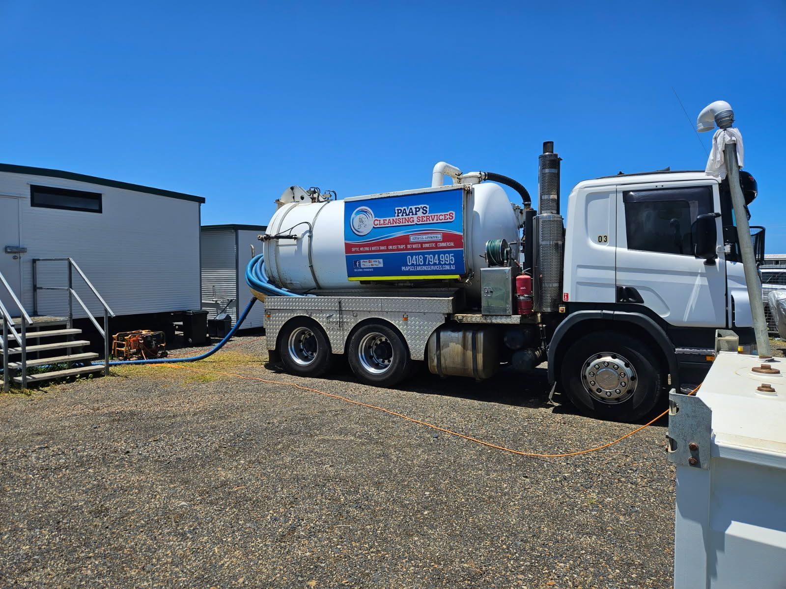 Septic Tank Truck Servicing a Portable Restroom on a Sunny Day — Paap's Cleansing Services in Branyan, QLD