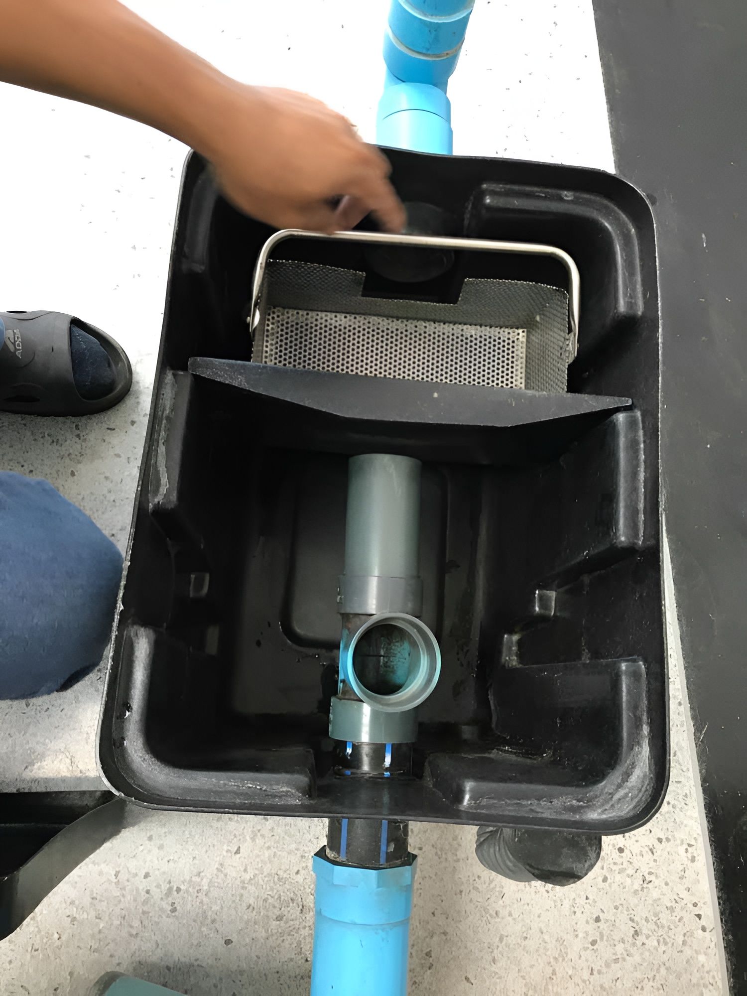 Open Black Rectangular Filter Box With Plumbing, a Hand Points Inside — Paap's Cleansing Services in Branyan, QLD