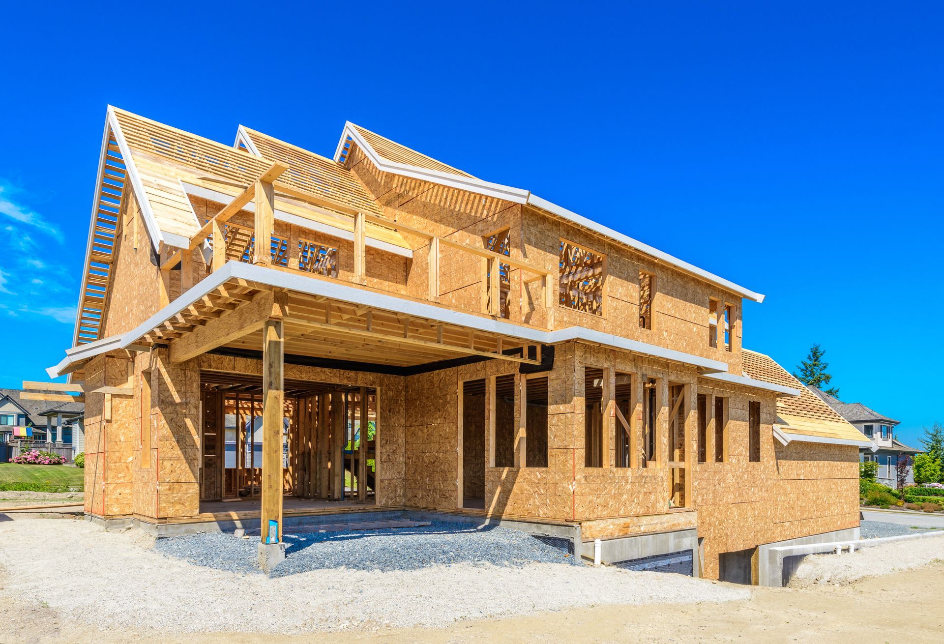 a large wooden house is being built in a residential area .