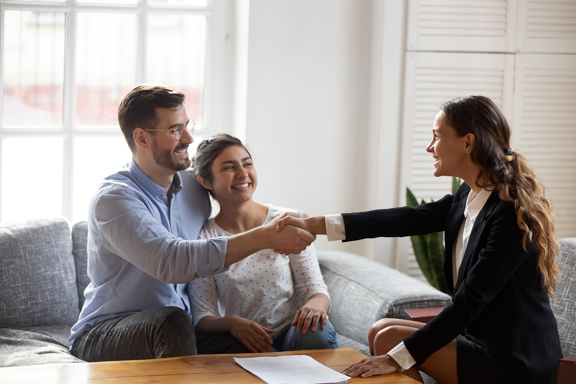 Couple Shaking Hands With Insurance Agent
