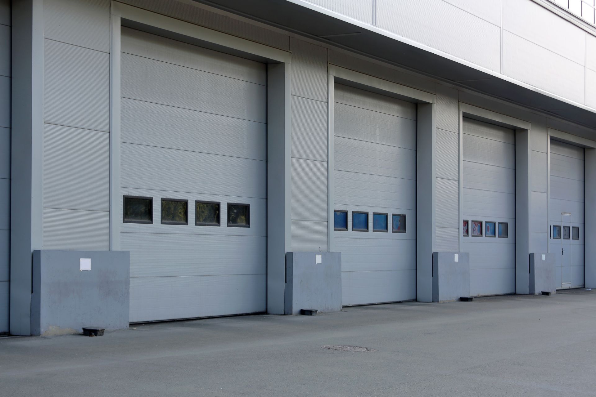 Garage door repair for commercial overhead doors at an industrial loading dock.