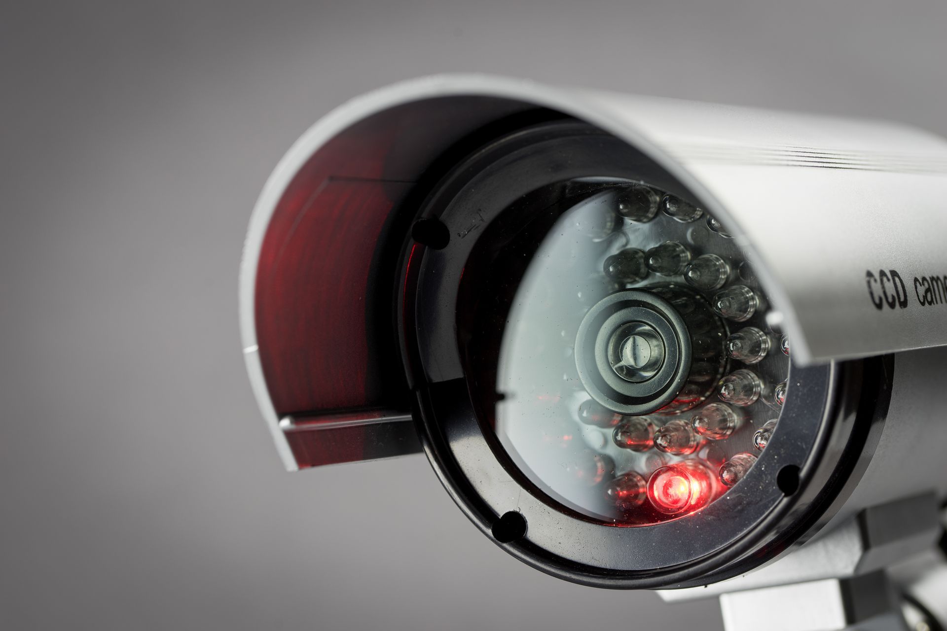Person holding security cameras and tools.