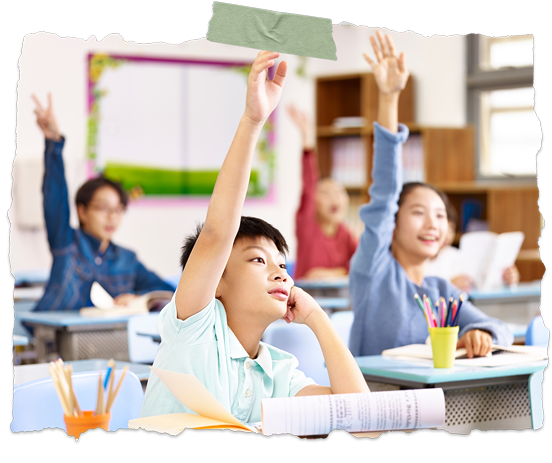 Students in a classroom raising their hands during a lesson