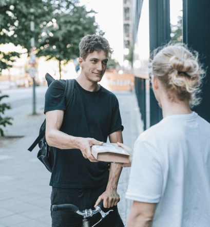 A customer receiving a package from a biker - Baltimore, MD - Magic Messengers A customer receiving a package from a biker - Baltimore, MD - Magic Messengers
