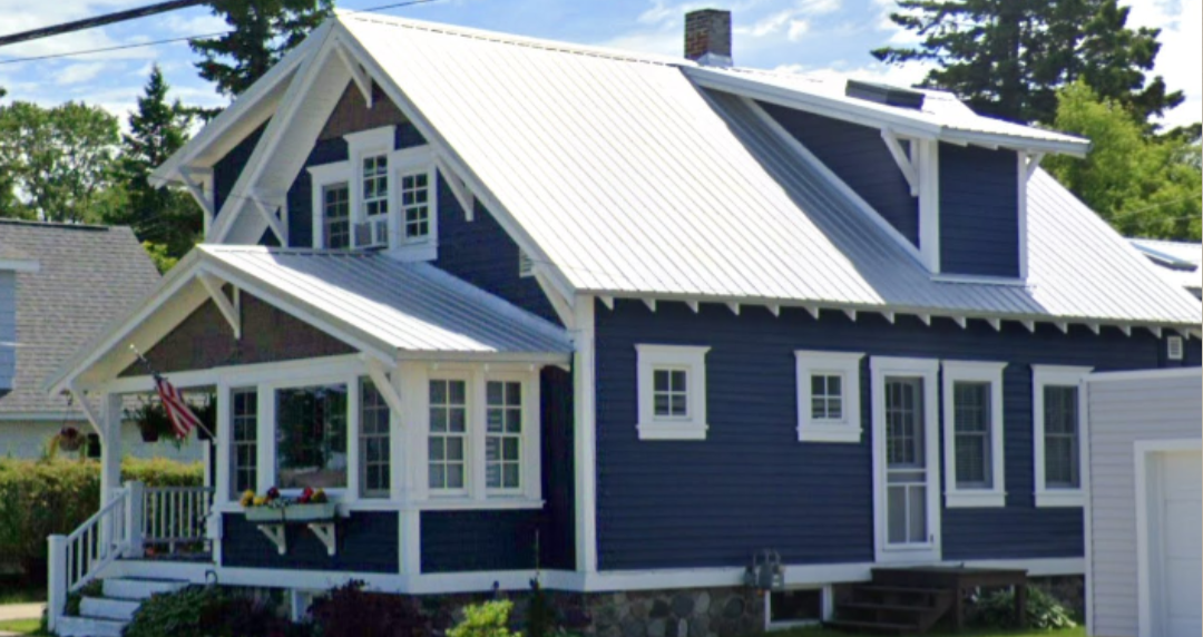 Blue house with white trim, metal roof.
