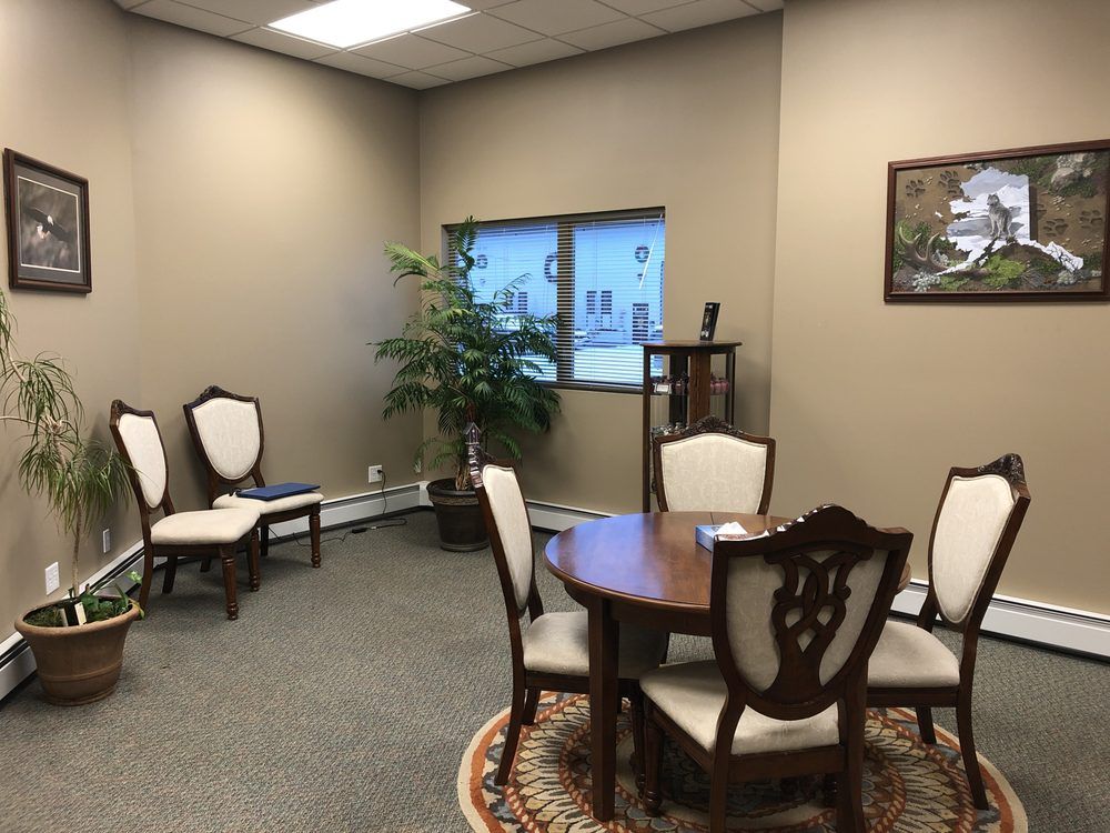 A room with a table and chairs 