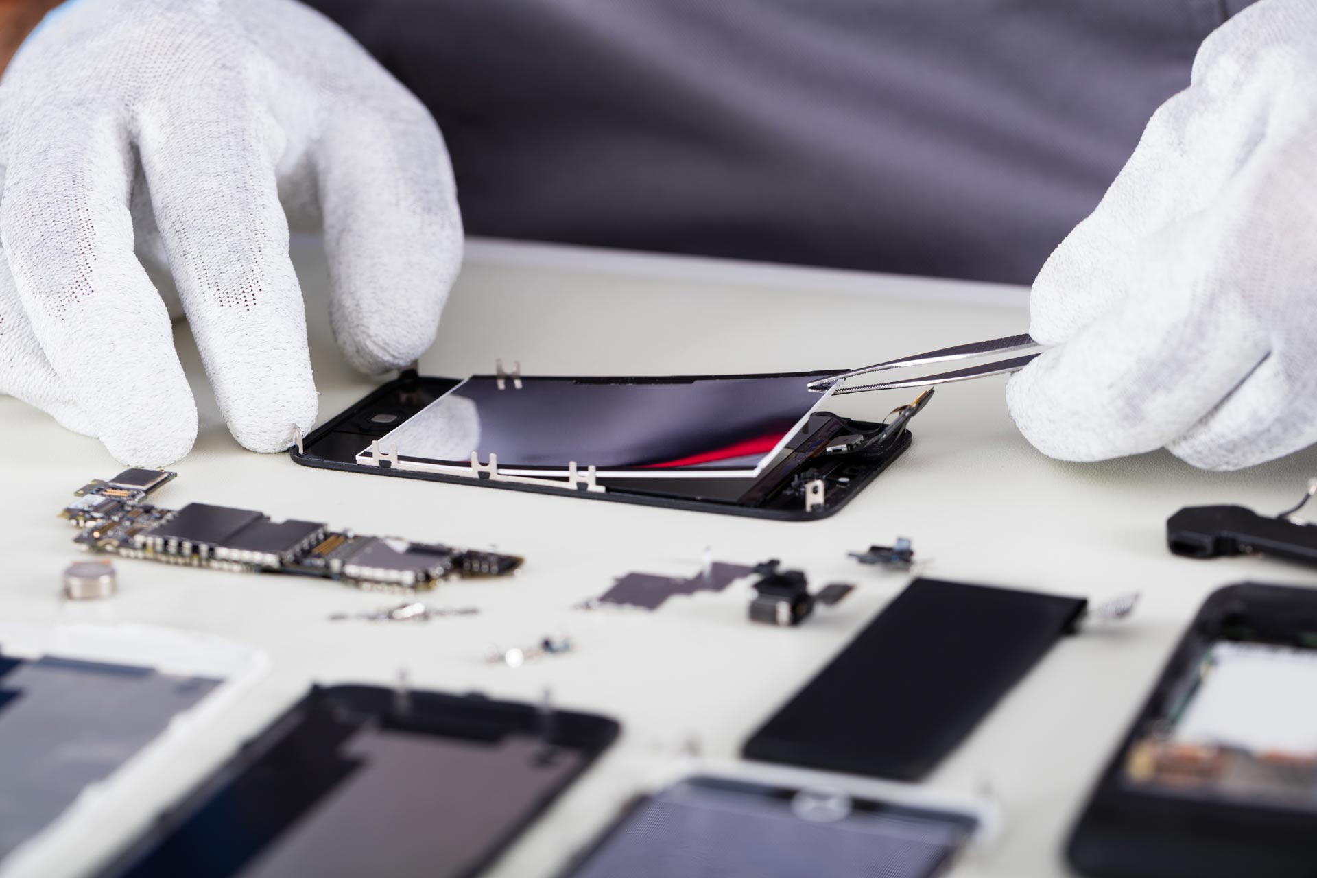 Repairman-Disassembling-Smartphone-With-Tweezers