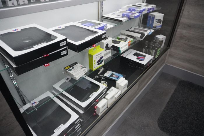 A display case filled with a variety of electronic devices.