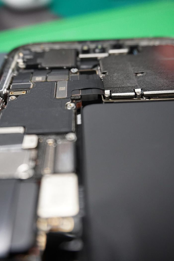 A close up of the inside of an iphone with the battery removed.