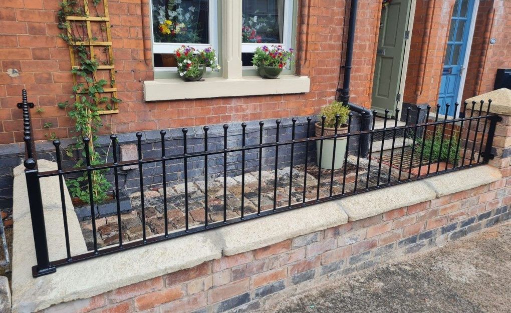 Ball-top railings along the front garden walls of a Victorian terrace