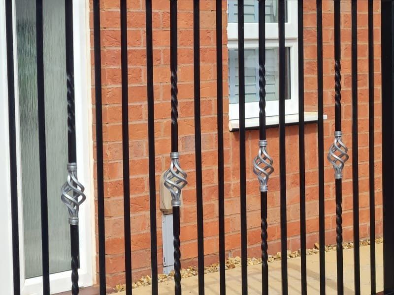 Silver basket twists on twisted black railing bars