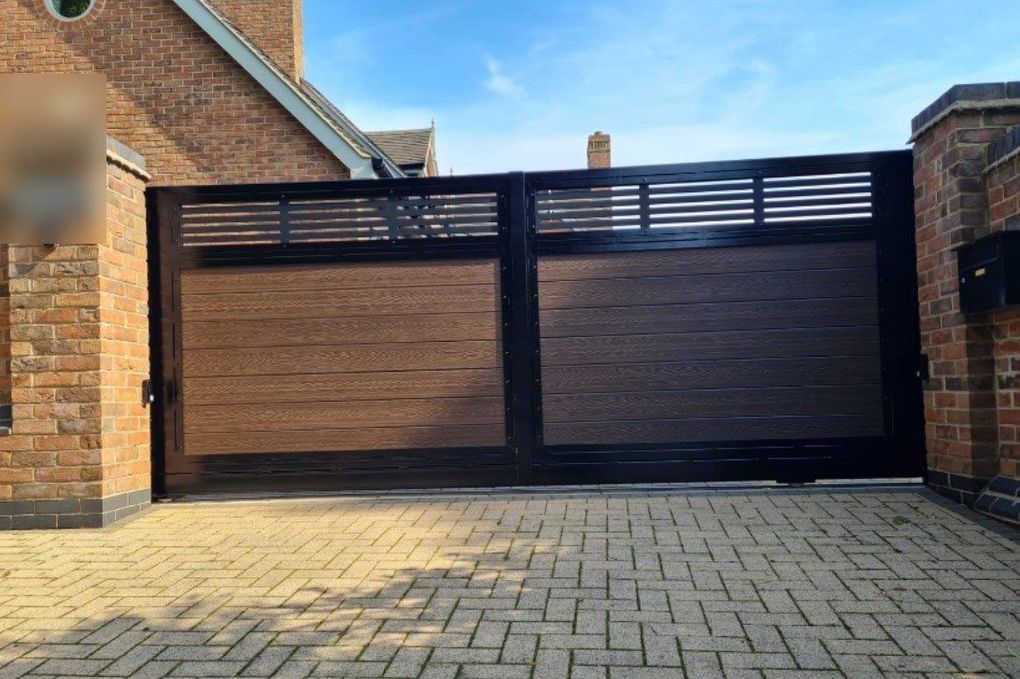 Electric sliding composite gate with brown wood-effect boards and a slatted top