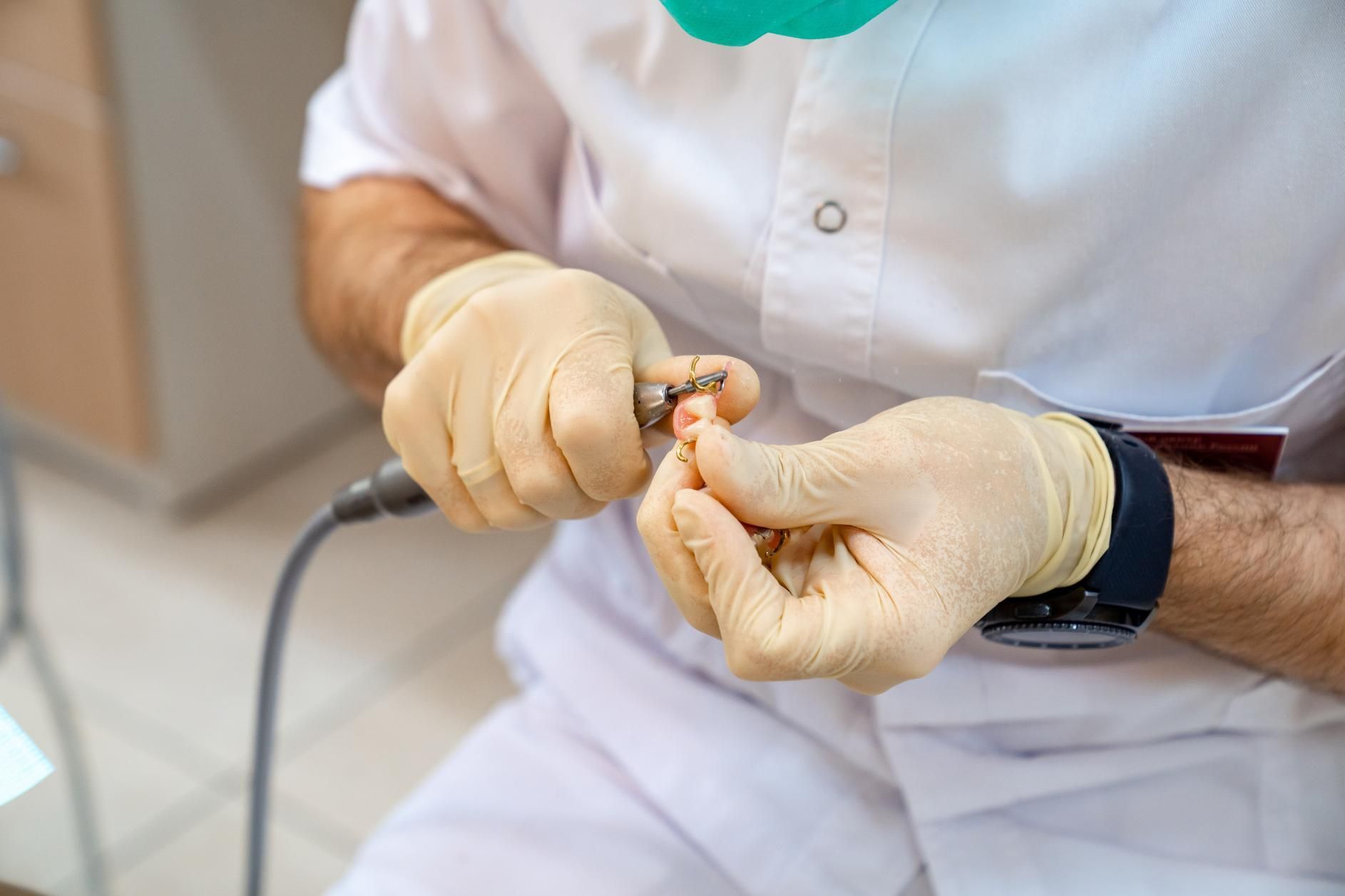 A dentist is adjust size denture.