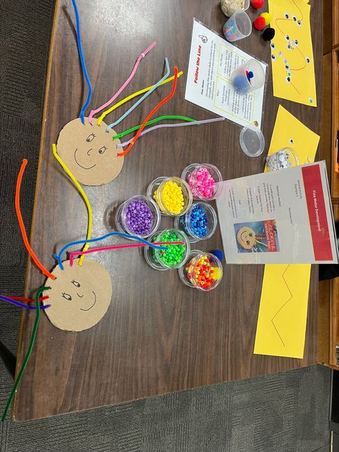 Children and caregivers participating in a Mobile Early Learning activity