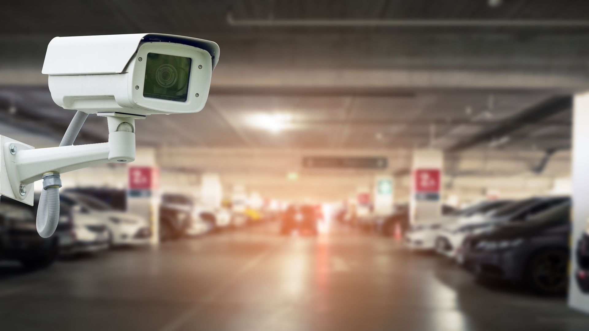 A security camera is sitting in a parking garage.