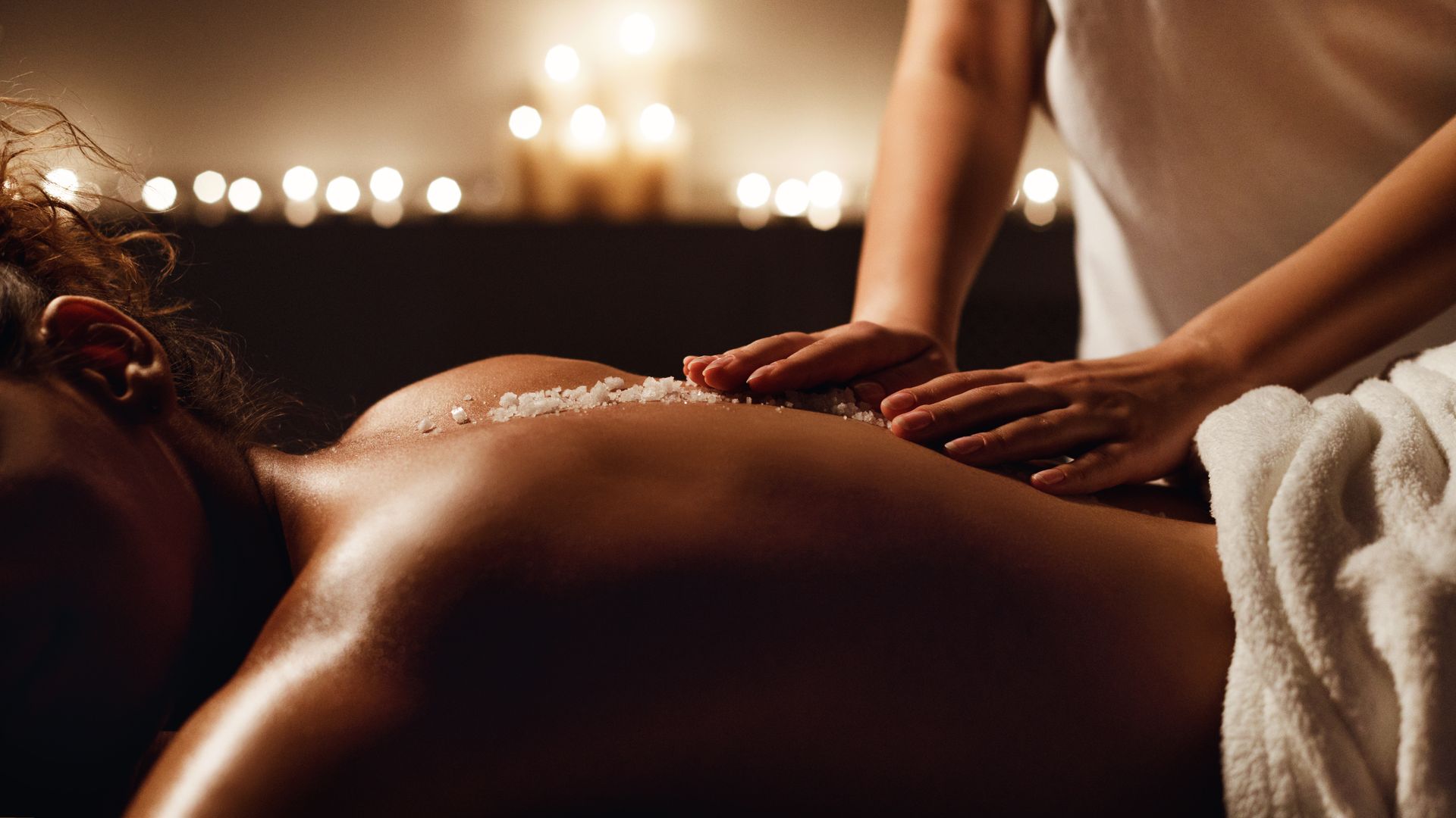 A woman is getting a head massage at a spa.