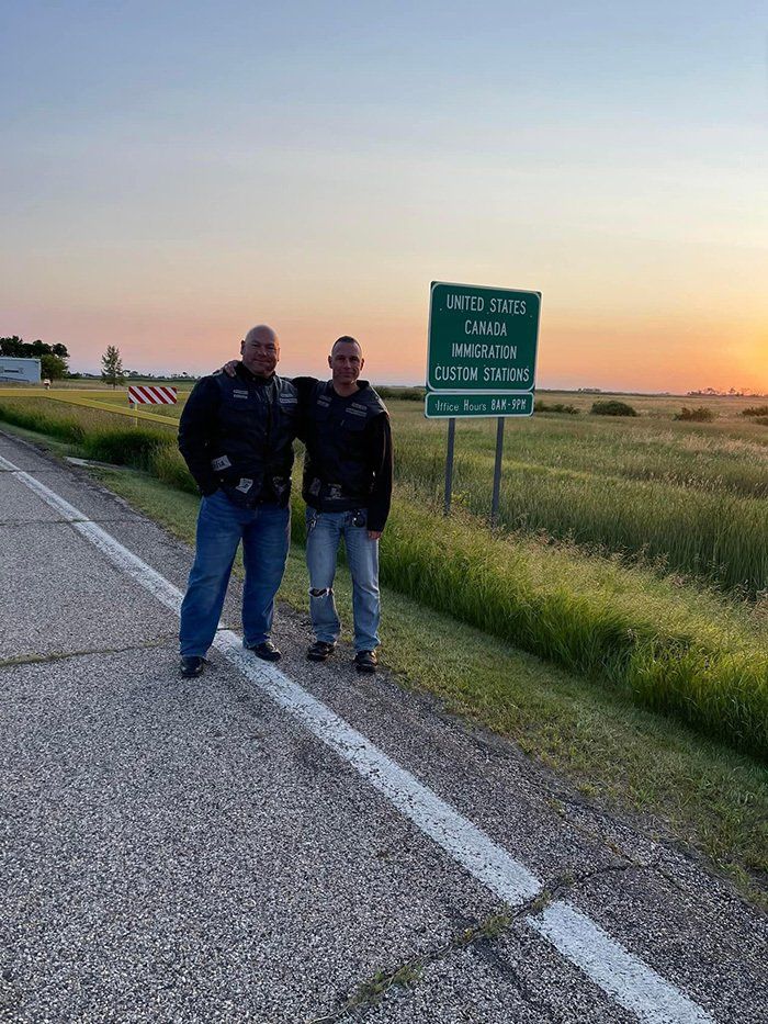 people posing in front of sign