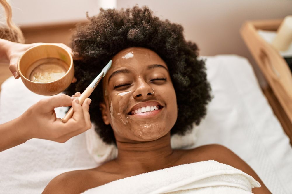 A woman is getting a facial treatment at a spa.