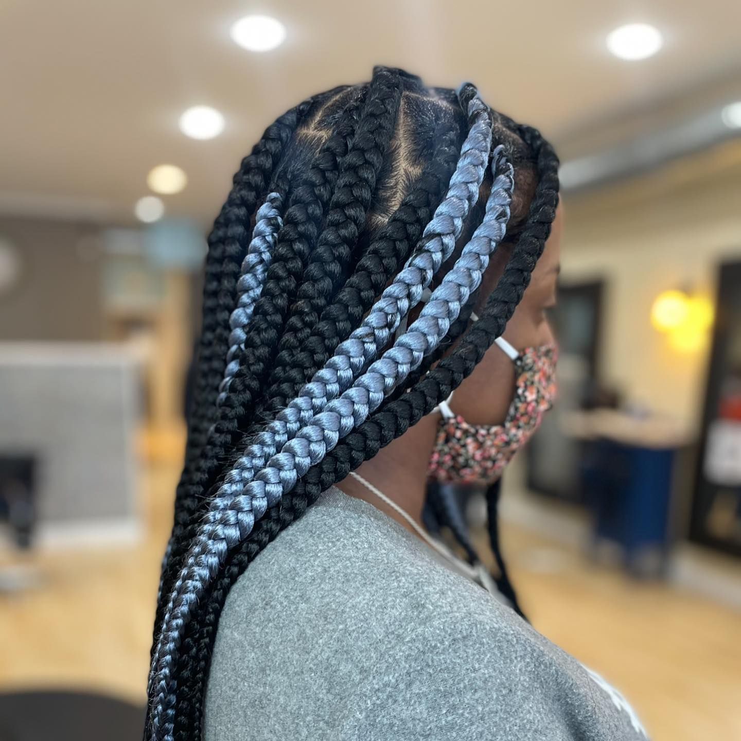 A woman with braids wearing a face mask