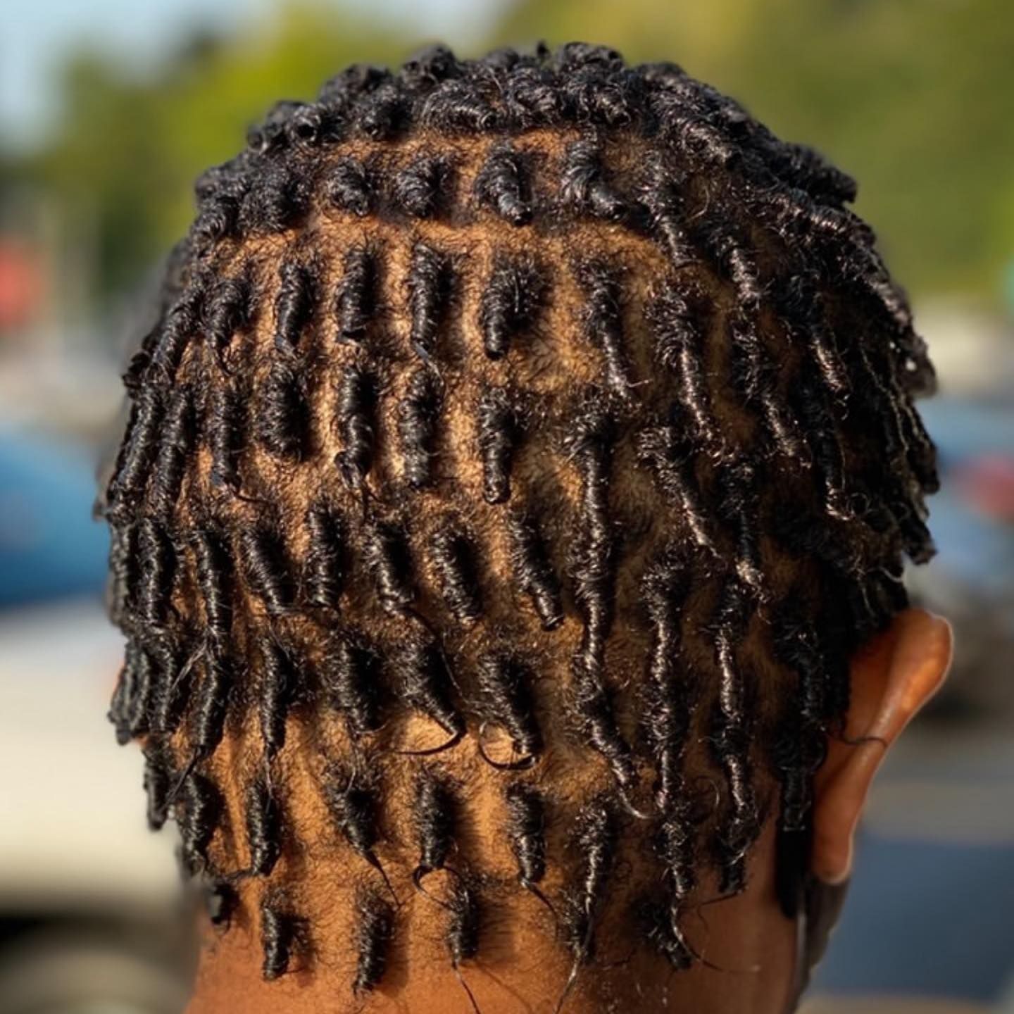 A close up of a person 's hair with dreadlocks