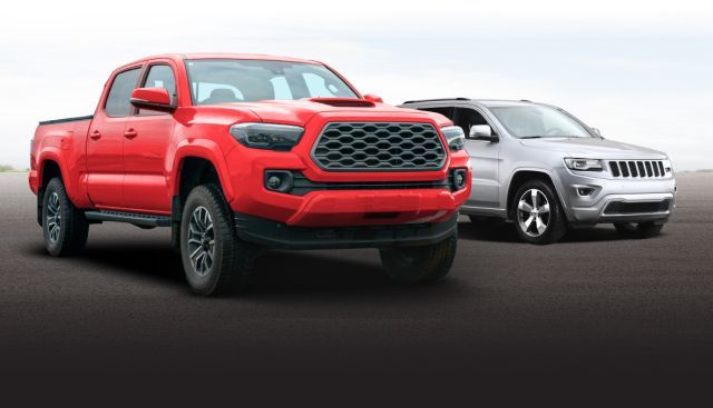 Red pickup truck and silver SUV on a road against a white background | Paul's Automotive