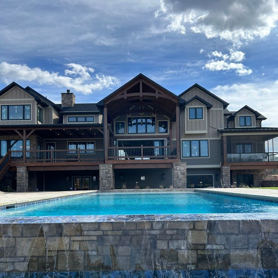 a large house with a swimming pool in front of it
