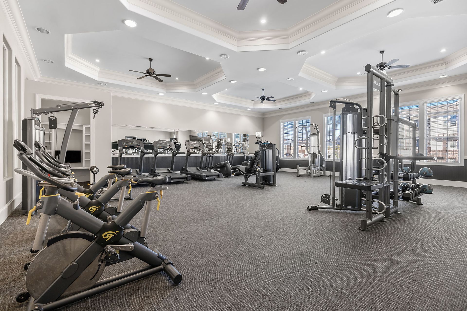 A large gym filled with lots of exercise equipment at Marquis Ellis Crossing offers apartments for rent in Durham, NC.