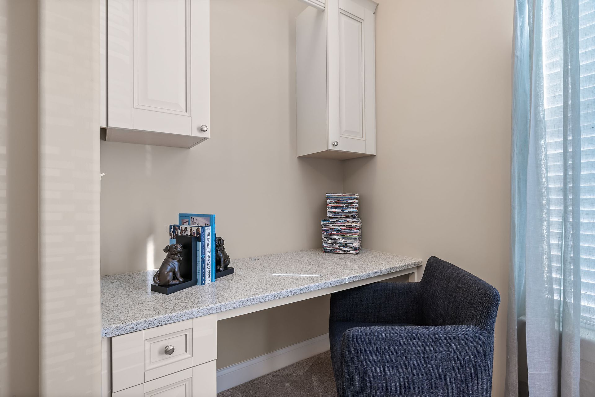 There is a desk with a chair in the corner of the room for wfh at Marquis Ellis Crossing offers apartments for rent in Durham, NC.