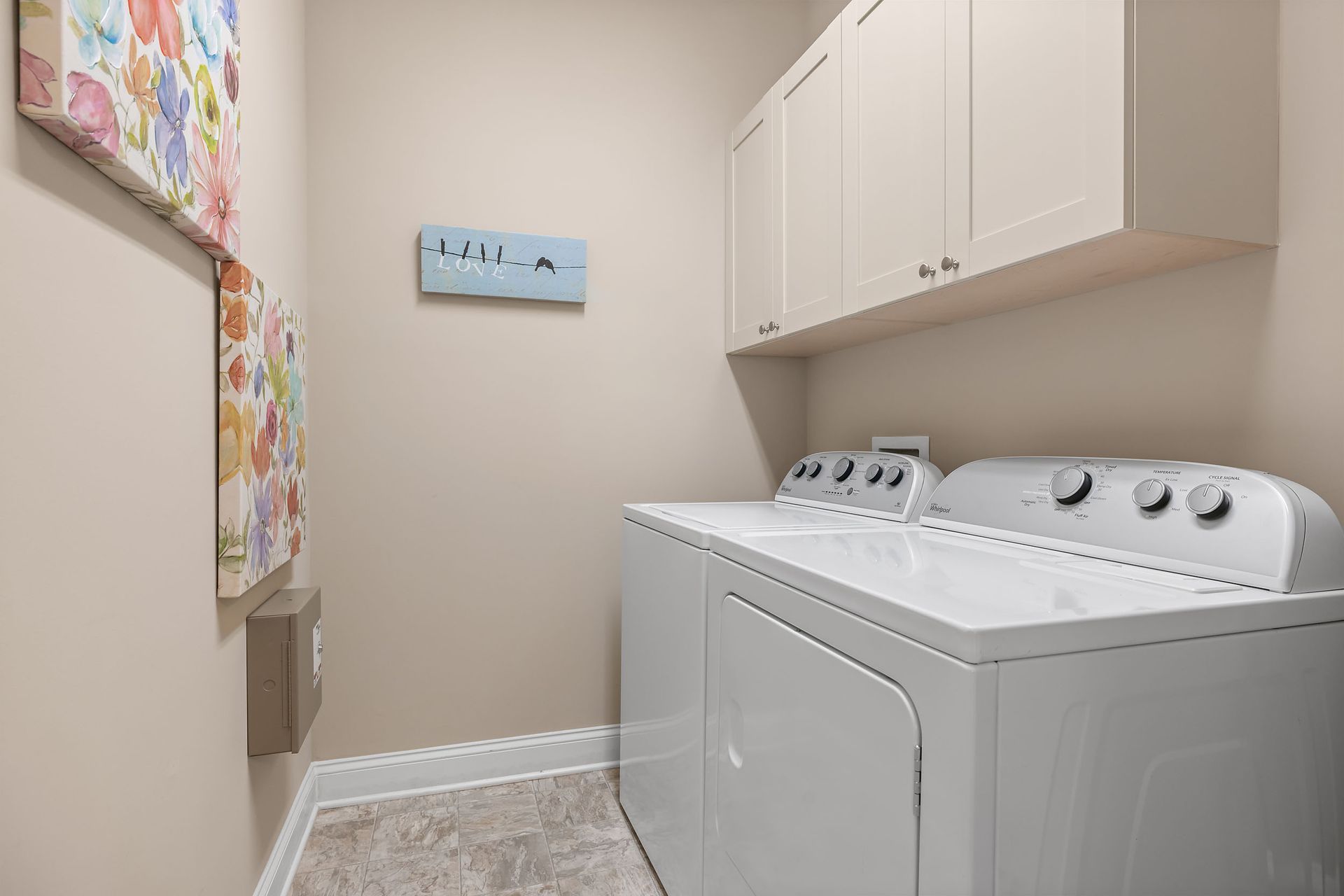 An artist's impression of a laundry room with a washer and dryer at Marquis Ellis Crossing offers apartments for rent in Durham, NC.