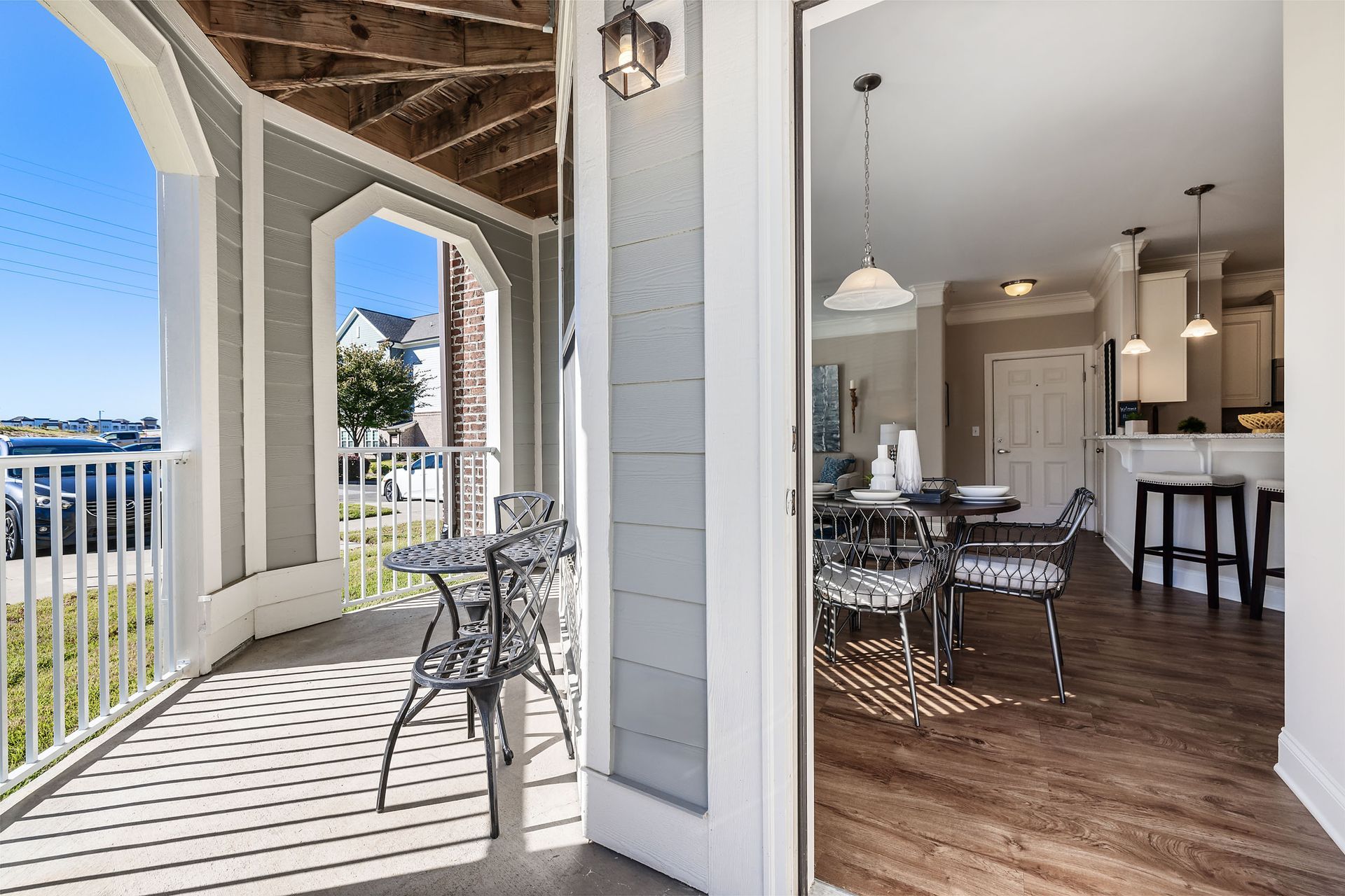 A porch with a table and chairs and a kitchen in the background at Marquis Ellis Crossing offers apartments for rent in Durham, NC.