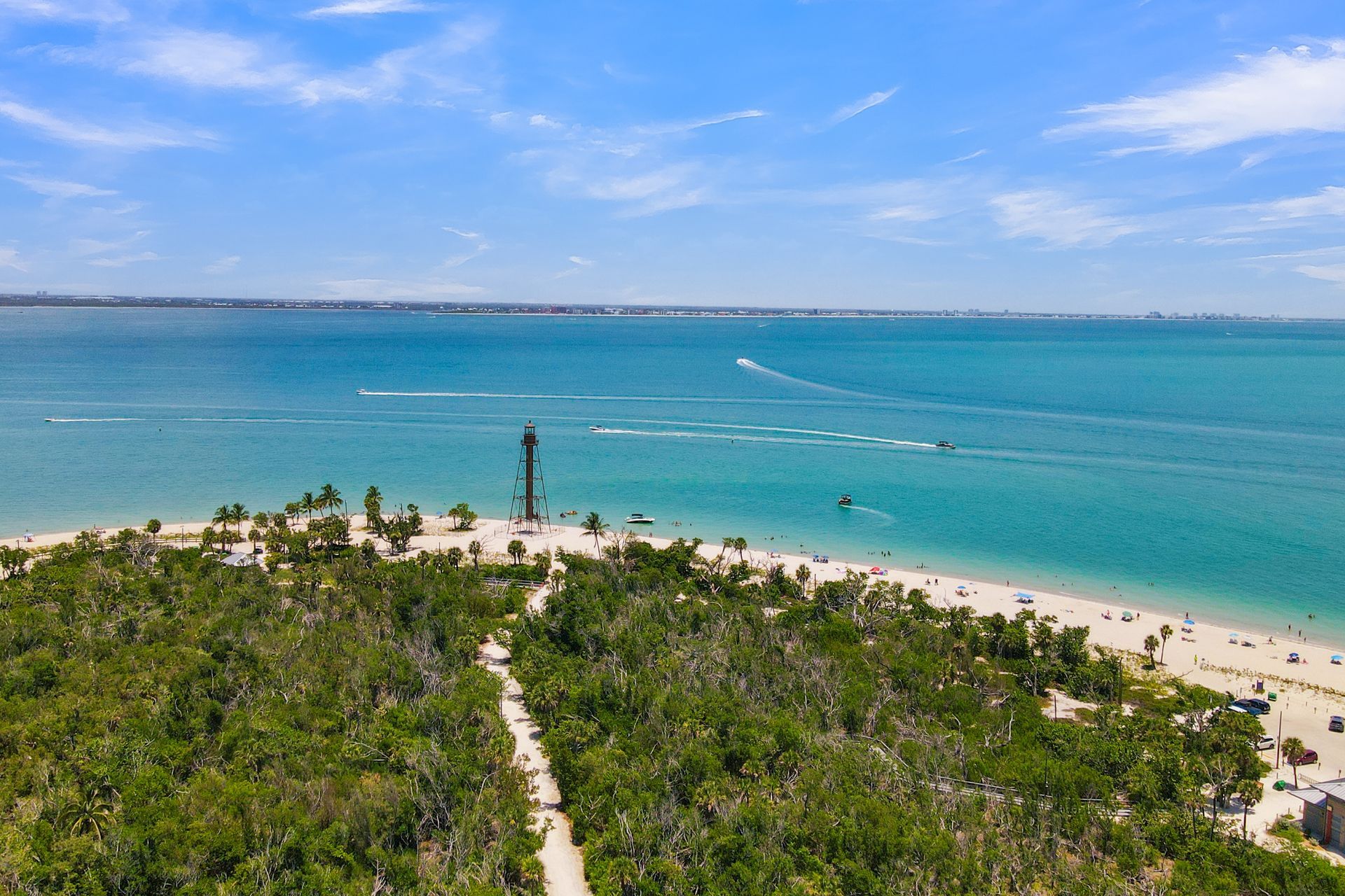 Turquoise ocean beside a sandy beach and resort buildings under a blue sky Turquoise ocean beside a sandy beach and resort buildings under a blue sky