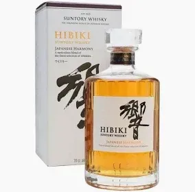Suntory Hibiki Japanese Harmony whisky bottle beside its white box, amber liquid visible