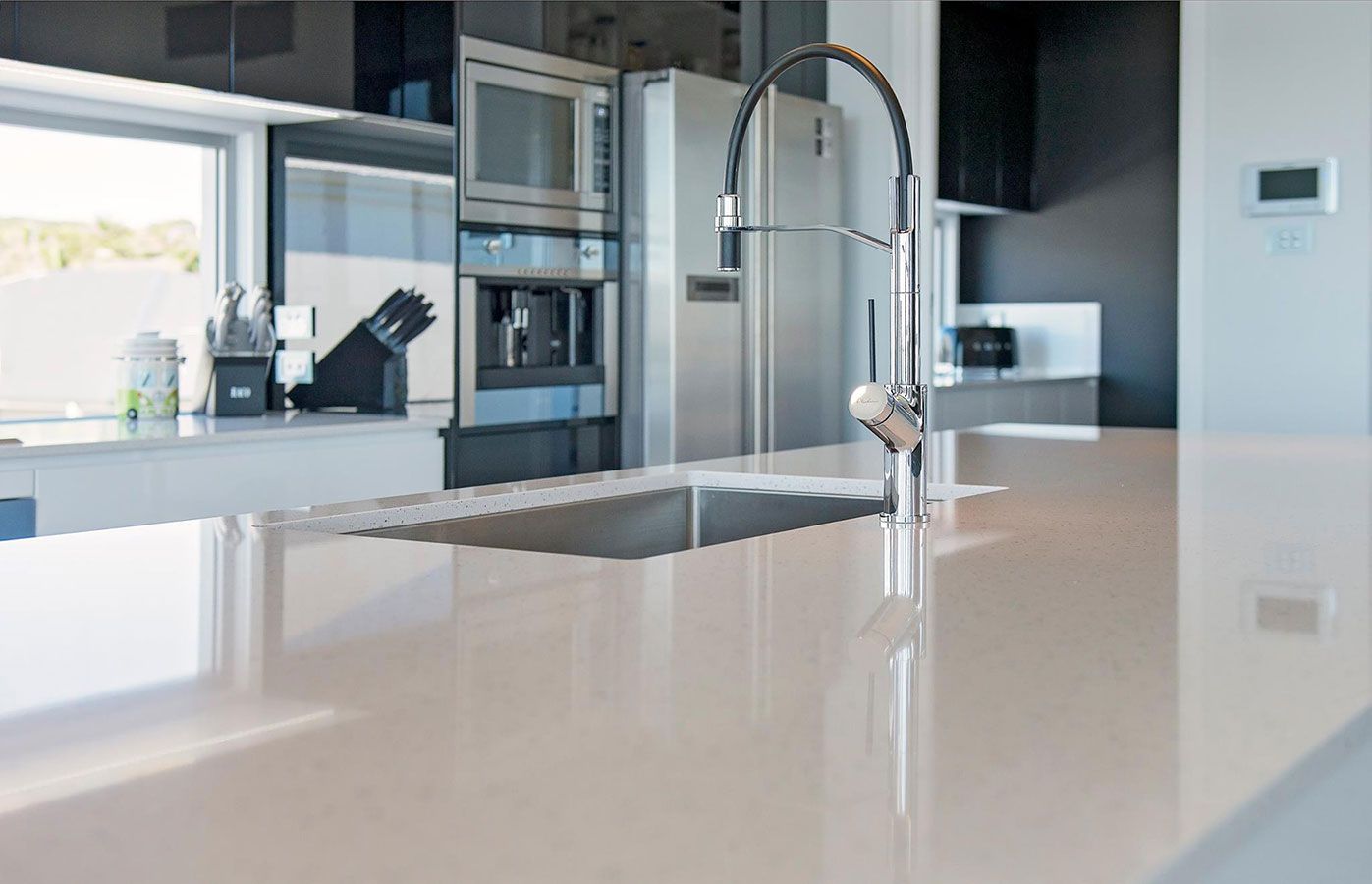 A Kitchen With a Sink and a Faucet on the Counter — Allnew Kitchens in Charmhaven, NSW