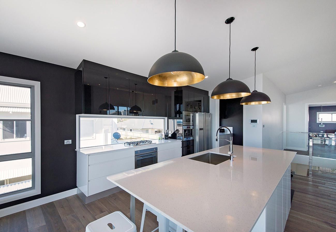 A Kitchen With a Large Island and a Sink — Allnew Kitchens in Charmhaven, NSW