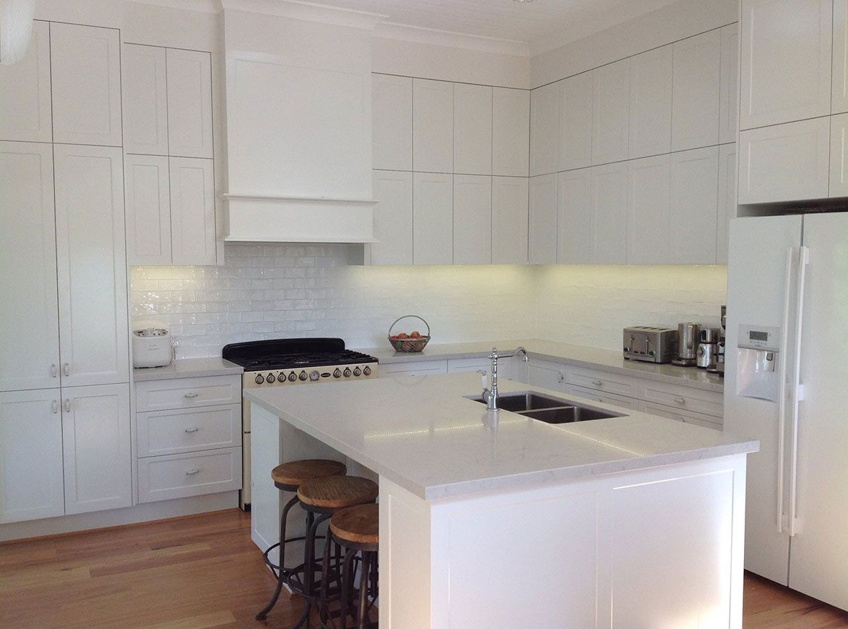 A Kitchen With White Cabinets and a Large Island — Allnew Kitchens in Charmhaven, NSW