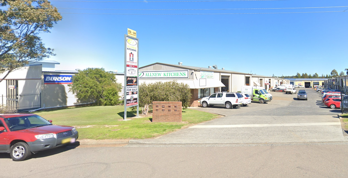 A Man is Installing a Sink in a Kitchen — Allnew Kitchens in Charmhaven, NSW