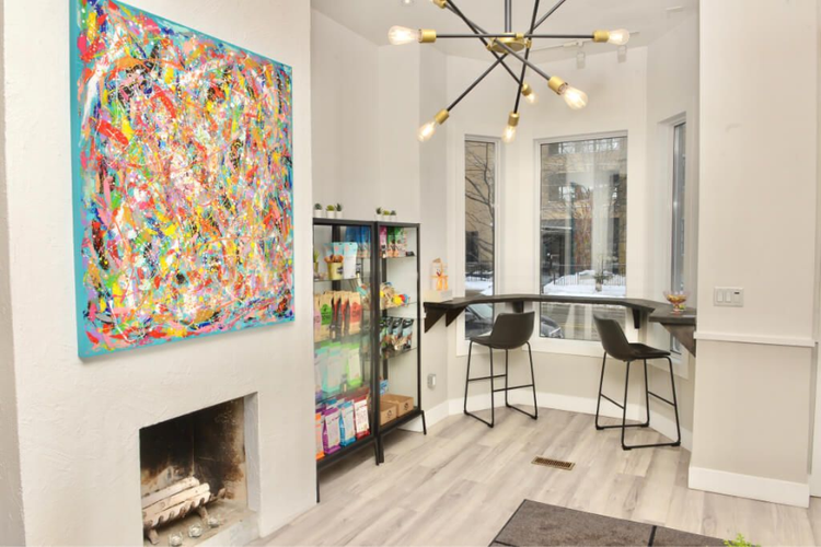Bright room with pet beds, rolling cart, lamp, and white cabinet on wood flooring