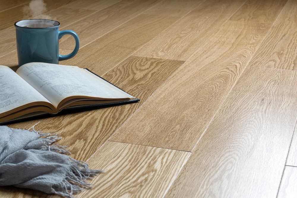Laminated Floor With Book And And A Cup Of Coffee  - Flooring in Kingaroy, QLD